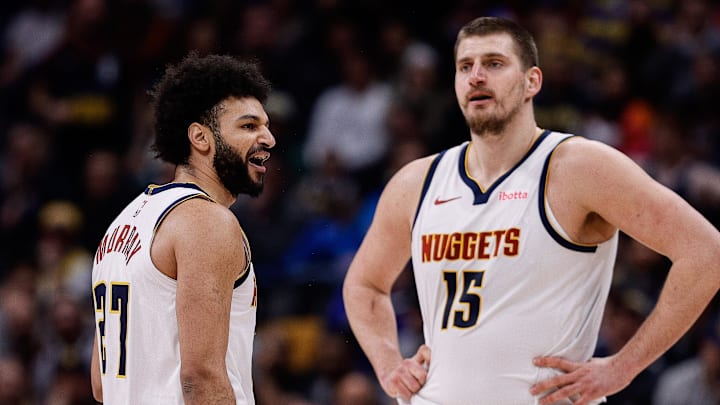 Feb 10, 2025; Denver, Colorado, USA; Denver Nuggets guard Jamal Murray (27) reacts after a call as center Nikola Jokic (15) looks on in the third quarter against the Portland Trail Blazers at Ball Arena.