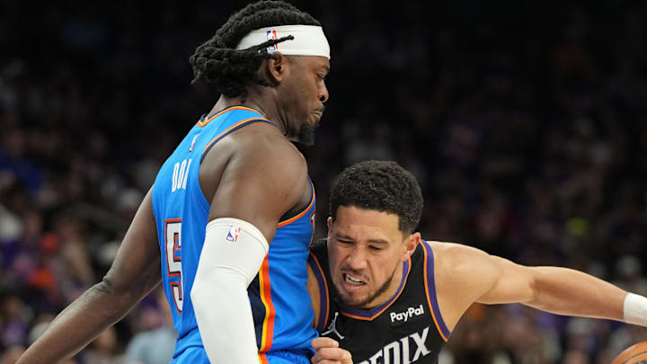 Apr 25, 2026; Phoenix, Arizona, USA; Phoenix Suns guard Devin Booker (1) drives on Oklahoma City Thunder guard Luguentz Dort (5) in the second half during game three of the first round of the 2026 NBA Playoffs at Mortgage Matchup Center. Mandatory Credit: Rick Scuteri-Imagn Images