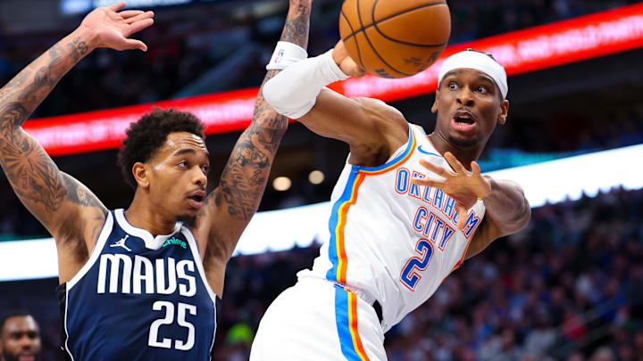 Feb 10, 2024; Dallas, Texas, USA; Oklahoma City Thunder guard Shai Gilgeous-Alexander (2) passes past Dallas Mavericks forward P.J. Washington (25) during the first half at American Airlines Center. Mandatory Credit: Kevin Jairaj-Imagn Images