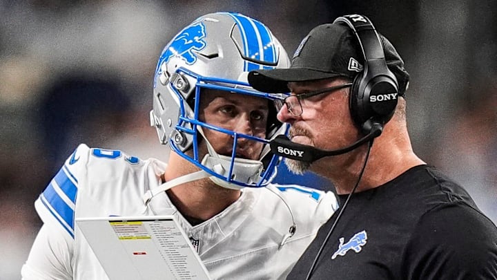 Detroit Lions quarterback Jared Goff (16) talks to head coach Dan Campbell before a play against Dallas Cowboys 