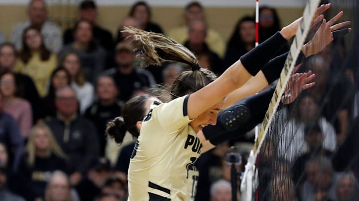 Purdue middle blocker Lizzie Carr (15) and Purdue outside hitter Eva Hudson (17) 