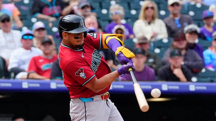 Sep 24, 2026; Denver, Colorado, USA;  Arizona Diamondbacks designated hitter Gabriel Moreno (14) hits a three-run home run in the first inning against the Colorado Rockies at Coors Field.  Mandatory Credit: Ron Chenoy-Imagn Images