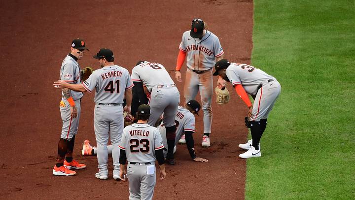 Boston, Massachusetts, USA; San Francisco Giants left fielder Victor Bericoto (78) appears to be injured after making an attempt to catch a foul ball during the fifth inning against the Boston Red Sox at Fenway Park. Mandatory Credit: Bob DeChiara-Imagn Images