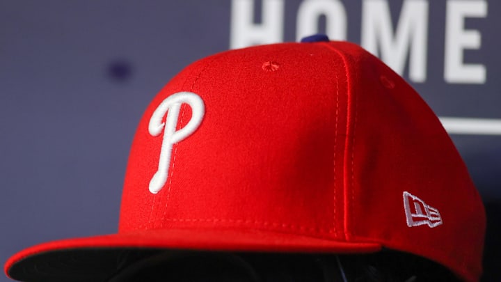 May 26, 2023; Atlanta, Georgia, USA; A detailed view of a Philadelphia Phillies hat and glove on the bench against the Atlanta Braves in the seventh inning at Truist Park. 