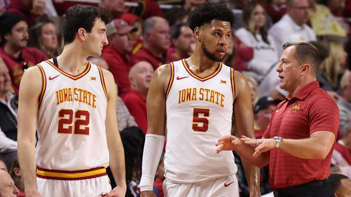 Jan 10, 2026; Ames, Iowa, USA; Iowa State Cyclones head coach T.J. Otzelberger talks with Iowa State Cyclones forward Milan Momcilovic (22) and Iowa State Cyclones forward Joshua Jefferson (5) in their game with the  Oklahoma State Cowboys during the first half at James H. Hilton Coliseum.