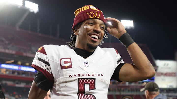 Jan 12, 2025; Tampa, Florida, USA; Washington Commanders quarterback Jayden Daniels (5) celebrates after winning a NFC wild card playoff against the Tampa Bay Buccaneers at Raymond James Stadium. Mandatory Credit: Nathan Ray Seebeck-Imagn Images