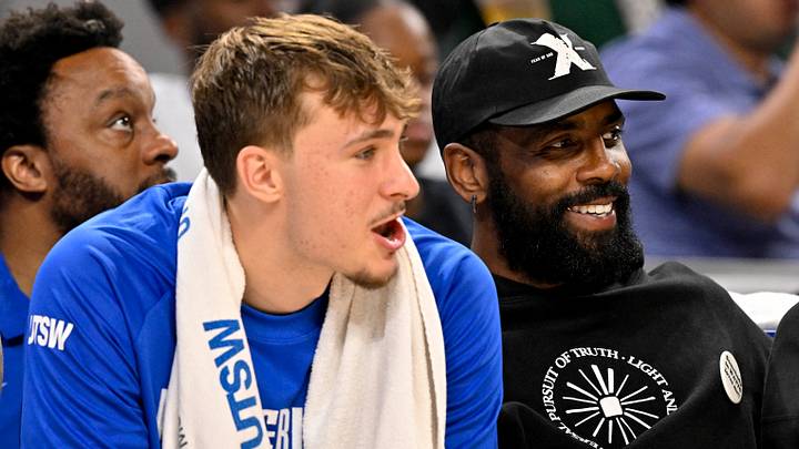 Oct 6, 2025; Fort Worth, Texas, USA; Dallas Mavericks forward Cooper Flagg (left) and guard Kyrie Irving (right) watch the game against the Oklahoma City Thunder during the second half at Dickie's Arena. Mandatory Credit: Jerome Miron-Imagn Images