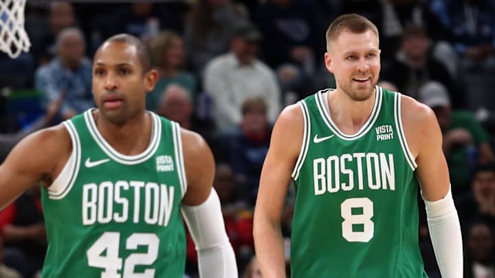 Nov 19, 2023; Memphis, Tennessee, USA; Boston Celtics center Al Horford (42) and center Kristaps Porzingis (8) get back on defense during the first half against the Memphis Grizzlies at FedExForum. Mandatory Credit: Petre Thomas-Imagn Images