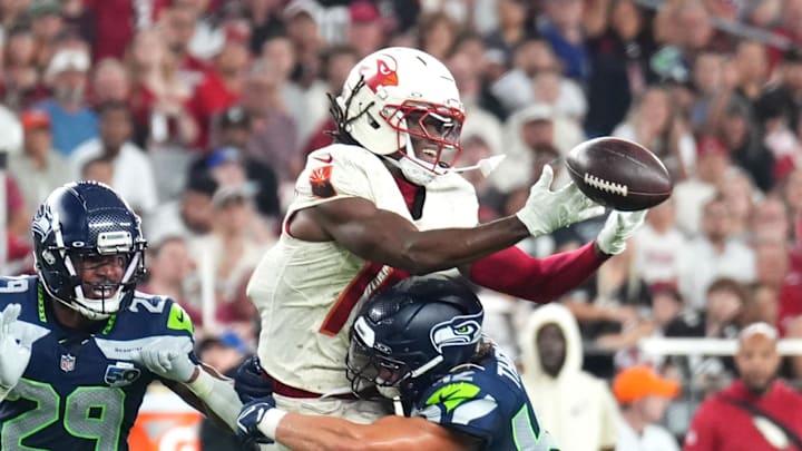 Sep 25, 2025; Glendale, Arizona, USA; Arizona Cardinals wide receiver Marvin Harrison Jr. (18) cannot make a catch against Seattle Seahawks linebacker Drake Thomas (42) as linebacker Ernest Jones IV (13) intercepts the ball in the second quarter at State Farm Stadium. Mandatory Credit: Joe Camporeale-Imagn Images Sep 25, 2025; Glendale, Arizona, USA; Arizona Cardinals wide receiver Marvin Harrison Jr. (18) cannot make a catch against Seattle Seahawks linebacker Drake Thomas (42) as linebacker Ernest Jones IV (13) intercepts the ball in the second quarter at State Farm Stadium. Mandatory Credit: Joe Camporeale-Imagn Images