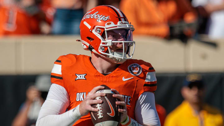 Oct 5, 2024; Stillwater, Oklahoma, USA; Oklahoma State Cowboys quarterback Alan Bowman (7) drops back to pass against the West Virginia Mountaineers during the first quarter at Boone Pickens Stadium. Mandatory Credit: William Purnell-Imagn Images