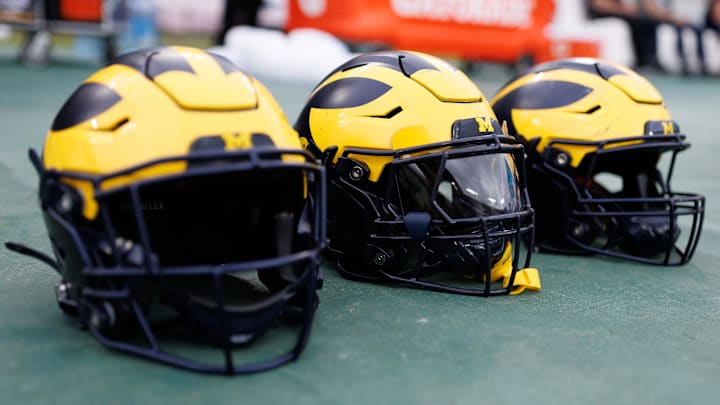 Dec 31, 2024; Tampa, FL, USA; Michigan Wolverines helmets sit on the field before a game against the Alabama Crimson Tide at Raymond James Stadium. Mandatory Credit: Matt Pendleton-Imagn Images