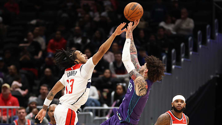 Feb 22, 2026; Washington, District of Columbia, USA; Charlotte Hornets guard LaMelo Ball (1) takes a shot over Washington Wizards guard Sharife Cooper (13) during the first half at Capital One Arena. Mandatory Credit: Daniel Kucin Jr.-Imagn Images Feb 22, 2026; Washington, District of Columbia, USA; Charlotte Hornets guard LaMelo Ball (1) takes a shot over Washington Wizards guard Sharife Cooper (13) during the first half at Capital One Arena. Mandatory Credit: Daniel Kucin Jr.-Imagn Images