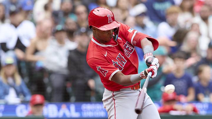 Los Angeles Angels shortstop Denzer Guzman (13) hits a single Los Angeles Angels shortstop Denzer Guzman (13) hits a single