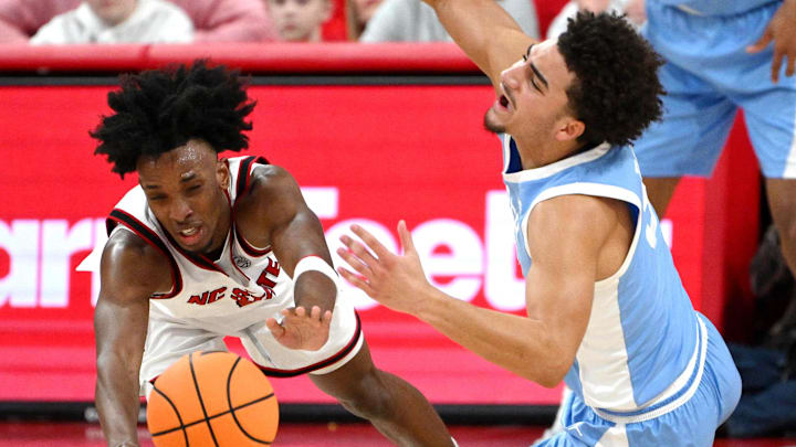 Feb 17, 2026; Raleigh, North Carolina, USA; NC State Wolfpack guard Paul McNeil Jr. (2) and North Carolina Tar Heels guard Derek Dixon (3) dive for the ball during the first half at Lenovo Center. Mandatory Credit: Zachary Taft-Imagn Images Feb 17, 2026; Raleigh, North Carolina, USA; NC State Wolfpack guard Paul McNeil Jr. (2) and North Carolina Tar Heels guard Derek Dixon (3) dive for the ball during the first half at Lenovo Center. Mandatory Credit: Zachary Taft-Imagn Images