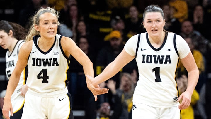 Iowa guard Kylie Feuerbach (4) high-fives Iowa guard Taylor Stremlow (1) during a basketball game against the Michigan Wolverines Feb. 22, 2026 at Carver-Hawkeye Arena in Iowa City, Iowa.