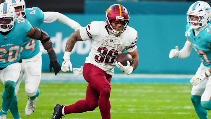 Nov 16, 2025; Madrid, Spain; Washington Commanders running back Chris Rodriguez Jr. (36) carries the ball against the Miami Dolphins in the second quarter during the 2025 NFL Madrid Game at Santiago Bernabeu Stadium. Mandatory Credit: Kirby Lee-Imagn Images