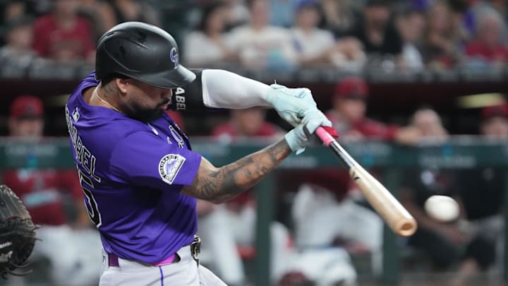 Colorado Rockies shortstop Warming Bernabel (25) bats against the Arizona Diamondbacks during the third inning at Chase Field. 