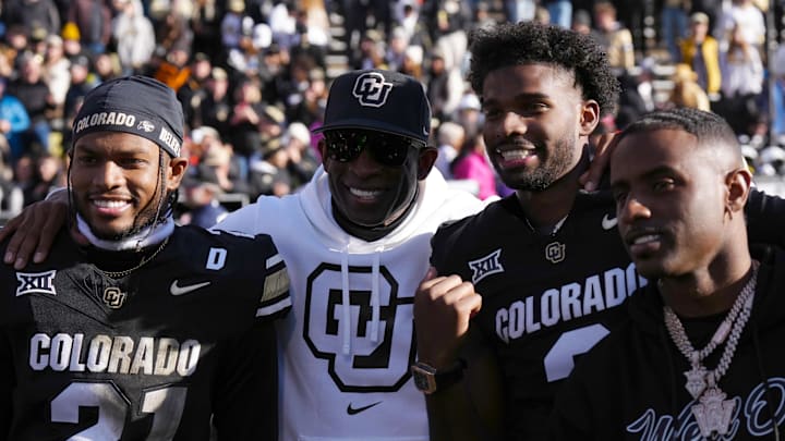 Nov 29, 2024; Boulder, Colorado, USA; Colorado Buffaloes safety Shilo Sanders (21) and head coach Deion Sanders and quarterback Shedeur Sanders (2) and social media producer Deion Sanders Jr. following the win against the Oklahoma State Cowboys at Folsom Field. Mandatory Credit: Ron Chenoy-Imagn Images Nov 29, 2024; Boulder, Colorado, USA; Colorado Buffaloes safety Shilo Sanders (21) and head coach Deion Sanders and quarterback Shedeur Sanders (2) and social media producer Deion Sanders Jr. following the win against the Oklahoma State Cowboys at Folsom Field. Mandatory Credit: Ron Chenoy-Imagn Images