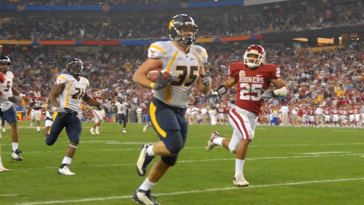 Jan 2, 2008; Glendale, AZ, USA; West Virginia Mountaineers running back Owen Schmitt (35) runs the ball for a second quarter touchdown against the Oklahoma Sooners during the Fiesta Bowl at University of Phoenix Stadium. Mandatory Credit: Mark J. Rebilas-Imagn Images