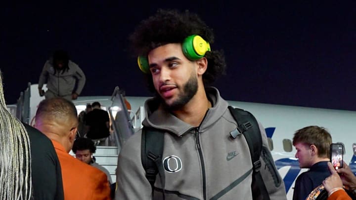 Oregon quarterback Dante Moore walks off the plane as the Oregon Ducks arrive in Miami, Florida on Dec. 29, 2025, ahead of the Orange Bowl.