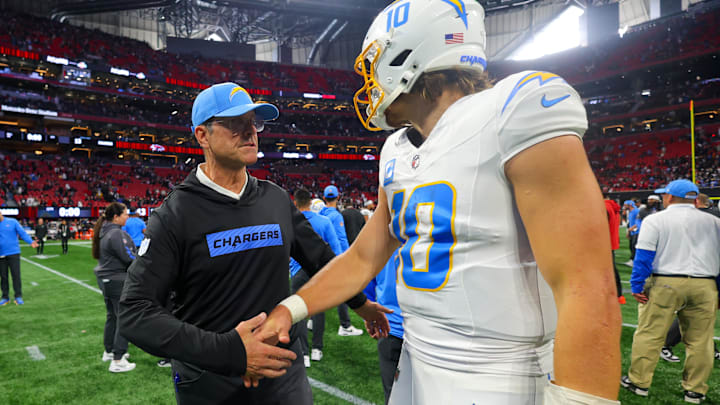 Dec 1, 2024; Atlanta, Georgia, USA; Los Angeles Chargers head coach Jim Harbaugh talks to quarterback Justin Herbert (10).