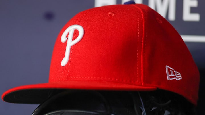 May 26, 2023; Atlanta, Georgia, USA; A detailed view of a Philadelphia Phillies hat and glove on the bench against the Atlanta Braves in the seventh inning at Truist Park.