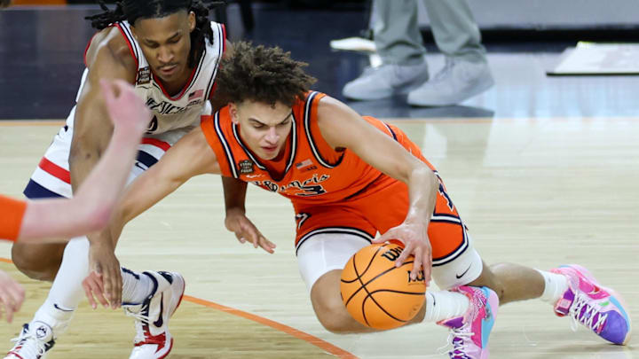 Apr 4, 2026; Indianapolis, IN, USA; Illinois Fighting Illini guard Keaton Wagler (23) loses his footing against UConn Huskies guard Silas Demary Jr. (2) in the second half during a semifinal of the Final Four. Apr 4, 2026; Indianapolis, IN, USA; Illinois Fighting Illini guard Keaton Wagler (23) loses his footing against UConn Huskies guard Silas Demary Jr. (2) in the second half during a semifinal of the Final Four.