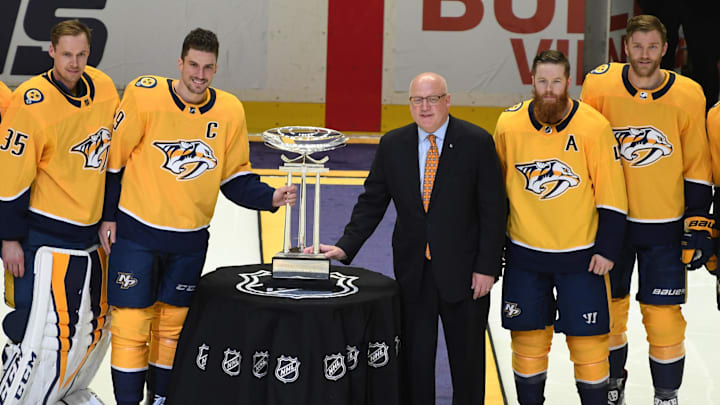 Apr 7, 2018; Nashville, TN, USA; (From left to right) Nashville Predators center Ryan Johansen (92) goalie Pekka Rinne (35)  defenseman Roman Josi (59) defenseman Ryan Ellis (4) defenseman Mattias Ekholm (14) and left wing Filip Forsberg (9) pose with NHL deputy commissioner Bill Daly as the Nashville Predators are awarded the Presidents' Trophy before the game against the Columbus Blue Jackets at Bridgestone Arena. Mandatory Credit: Christopher Hanewinckel-Imagn Images