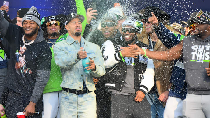 Feb 11, 2026; Seattle, WA, USA; Seattle Seahawks wide receiver Jaxon Smith-Njigba (11) sprays water during the Super Bowl LX trophy presentation at Lumen Field. Mandatory Credit: Steven Bisig-Imagn Images