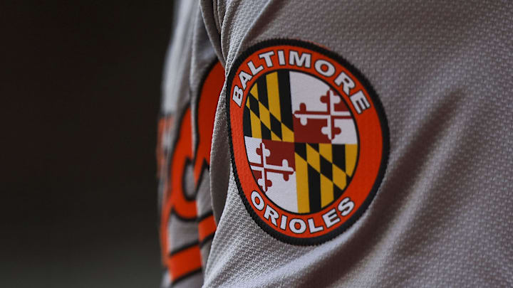 May 5, 2024; Cincinnati, Ohio, USA; The Baltimore Orioles logo on the sleeve of designated hitter Gunnar Henderson (2) as he prepares on deck during the seventh inning against the Cincinnati Reds at Great American Ball Park. Mandatory Credit: Katie Stratman-Imagn Images May 5, 2024; Cincinnati, Ohio, USA; The Baltimore Orioles logo on the sleeve of designated hitter Gunnar Henderson (2) as he prepares on deck during the seventh inning against the Cincinnati Reds at Great American Ball Park. Mandatory Credit: Katie Stratman-Imagn Images