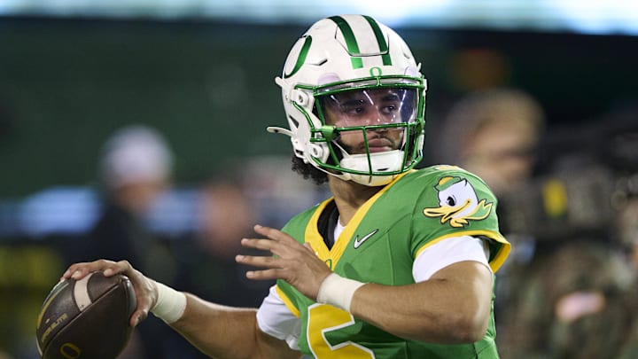 Nov 14, 2025; Eugene, Oregon, USA; Oregon Ducks quarterback Dante Moore (5) warms up before a game against the Minnesota Golden Gophers at Autzen Stadium. Mandatory Credit: Troy Wayrynen-Imagn Images