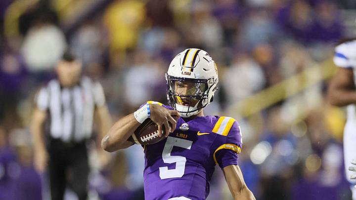 LSU Tigers quarterback Jayden Daniels (5) slides after a run as Georgia State Panthers safety Jeremiah Johnson (6) looks on in the third quarter at Tiger Stadium. LSU Tigers quarterback Jayden Daniels (5) slides after a run as Georgia State Panthers safety Jeremiah Johnson (6) looks on in the third quarter at Tiger Stadium.