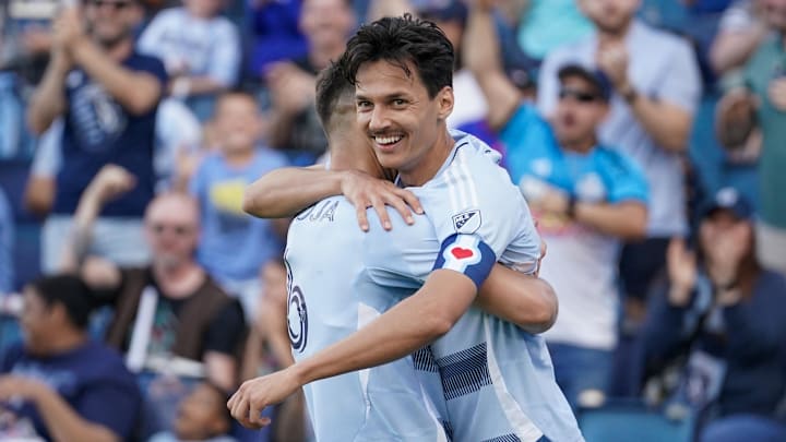 Daniel Salloi (left) celebrates with midfielder Nemanja Radoja after Maya Yoshida's own goal