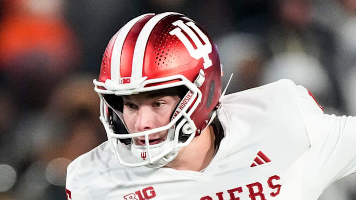 Indiana Hoosiers quarterback Fernando Mendoza (15) rushes up the field Friday, Nov. 28, 2025, during the 100th annual Old Oaken Bucket game at Ross-Ade Stadium in West Lafayette. Indiana Hoosiers quarterback Fernando Mendoza (15) rushes up the field Friday, Nov. 28, 2025, during the 100th annual Old Oaken Bucket game at Ross-Ade Stadium in West Lafayette.