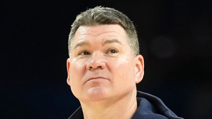 Apr 3, 2026; Indianapolis, IN, USA; Arizona Wildcats head coach Tommy Lloyd looks on during a practice session ahead of the Final Four of the men's 2026 NCAA Tournament at Lucas Oil Stadium. Mandatory Credit: Robert Deutsch-Imagn Images Apr 3, 2026; Indianapolis, IN, USA; Arizona Wildcats head coach Tommy Lloyd looks on during a practice session ahead of the Final Four of the men's 2026 NCAA Tournament at Lucas Oil Stadium. Mandatory Credit: Robert Deutsch-Imagn Images