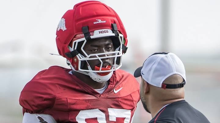 Arkansas Razorbacks defensive lineman Quincy Rhodes (97) listens to a coach before a drill during spring practice at the Arkansas Razorbacks practice facilities Arkansas Razorbacks defensive lineman Quincy Rhodes (97) listens to a coach before a drill during spring practice at the Arkansas Razorbacks practice facilities