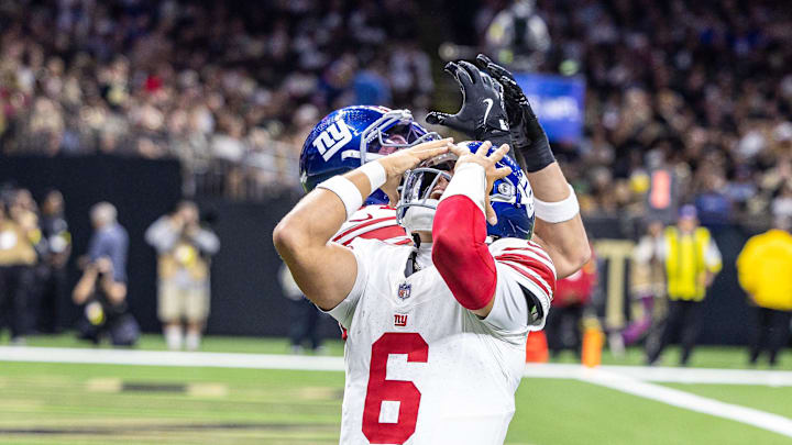 New York Giants tight end Theo Johnson and quarterback Jaxson Dart reacting in surprise.