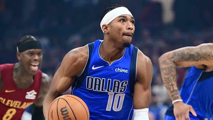 Mar 15, 2026; Cleveland, Ohio, USA; Dallas Mavericks guard Brandon Williams (10) brings the ball up court against the Cleveland Cavaliers during the first half at Rocket Arena.