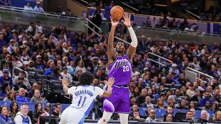 Feb 7, 2026; Orlando, Florida, USA; Utah Jazz center Jaren Jackson Jr. (20) shoots a three point basket in front of Orlando Magic guard Jase Richardson (11) during the second half at Kia Center. Mandatory Credit: Mike Watters-Imagn Images
