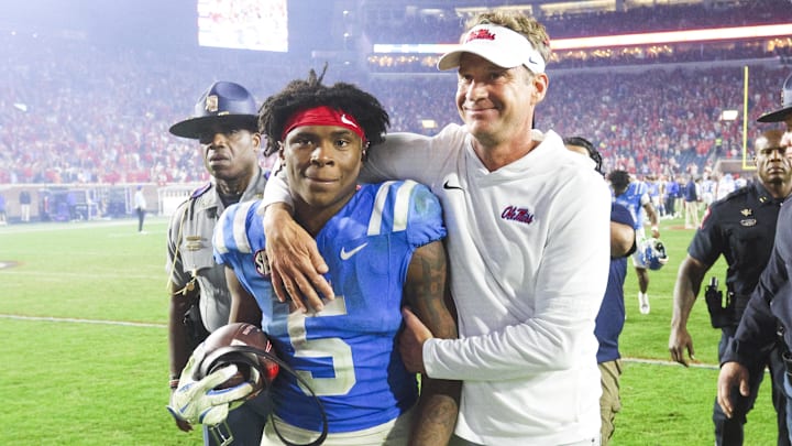 Nov 15, 2025; Oxford, Mississippi, USA; Mississippi Rebels head coach Lane Kiffin embraces running back Kewan Lacy (5) after defeating the Florida Gators at Vaught-Hemingway Stadium. Mandatory Credit: Petre Thomas-Imagn Images