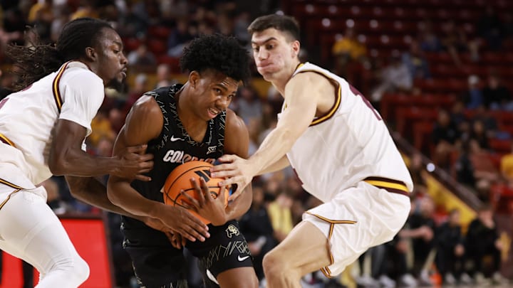 Jan 3, 2026; Tempe, Arizona, USA; Colorado Buffaloes guard Isaiah Johnson (center) drives to the basket against Arizona State Sun Devils guard Anthony Johnson (left) and forward Andrija Grbovic in the first half at Desert Financial Arena. Mandatory Credit: Mark J. Rebilas-Imagn Images
