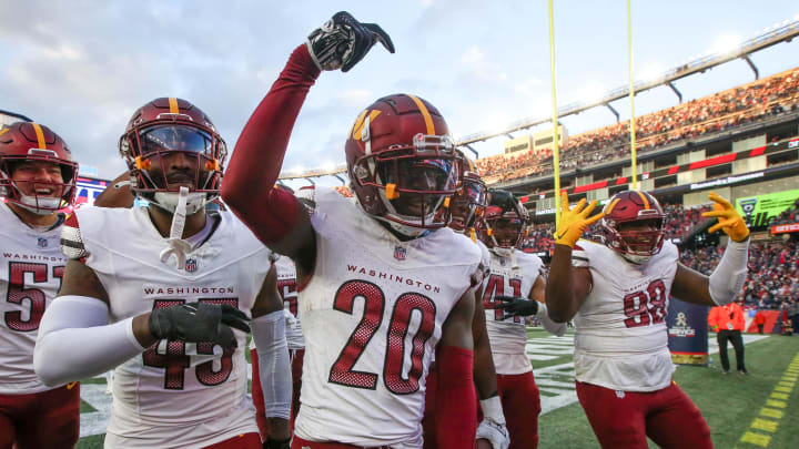 Nov 5, 2023; Foxborough, Massachusetts, USA; Washington Commanders cornerback Jartavius Martin (20) celebrates after an interception during the second half against the New England Patriots at Gillette Stadium. Mandatory Credit: Paul Rutherford-USA TODAY Sports