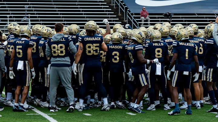 The Akron football team gathers before their 2025 season opener against Wyoming.