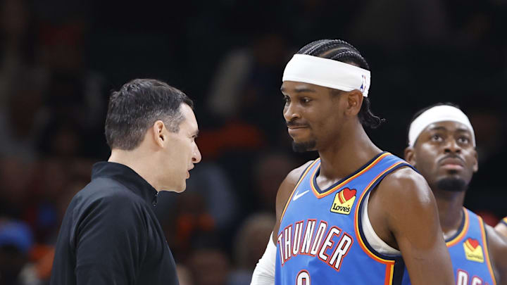 Nov 13, 2024; Oklahoma City, Oklahoma, USA; Oklahoma City Thunder guard Shai Gilgeous-Alexander (2) and head coach Mark Daigneault talk during a timeout against the New Orleans Pelicans during the second quarter at Paycom Center. Mandatory Credit: Alonzo Adams-Imagn Images