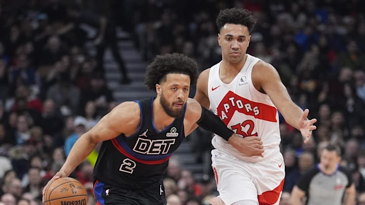 Feb 11, 2026; Toronto, Ontario, CAN; Detroit Pistons guard Cade Cunningham (2) dribbles past Toronto Raptors forward Trayce Jackson-Davis (32) during the first half at Scotiabank Arena. Mandatory Credit: John E. Sokolowski-Imagn Images