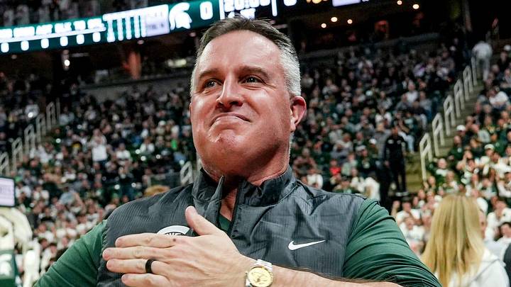 Michigan State's new football coach Pat Fitzgerald pats his heart at the crowd in attendance for the Spartans basketball game against Iowa on Tuesday, Dec. 2, 2025, at the Breslin Center in East Lansing.
