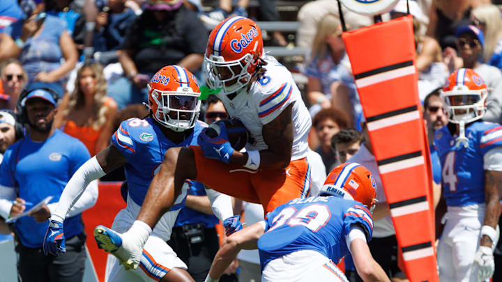 Apr 12, 2025; Gainesville, FL, USA; Florida Gators wide receiver Dallas Wilson (6) makes a catch over Florida Gators defensive back Micheal Caraway Jr. (16) and Florida Gators defensive back Brayden Slade (39) during the first half at Ben Hill Griffin Stadium. Mandatory Credit: Matt Pendleton-Imagn Images Apr 12, 2025; Gainesville, FL, USA; Florida Gators wide receiver Dallas Wilson (6) makes a catch over Florida Gators defensive back Micheal Caraway Jr. (16) and Florida Gators defensive back Brayden Slade (39) during the first half at Ben Hill Griffin Stadium. Mandatory Credit: Matt Pendleton-Imagn Images