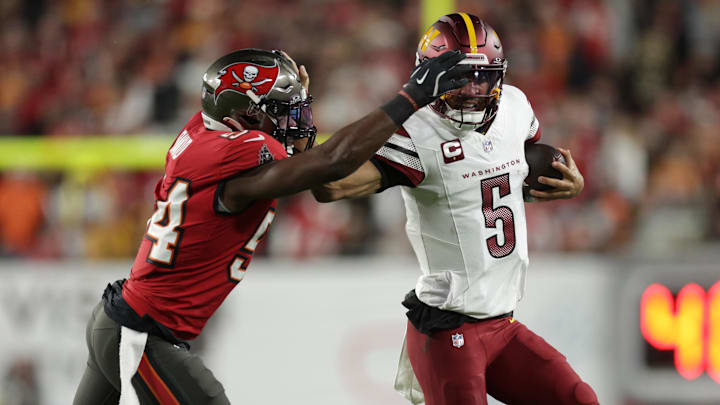 Jan 12, 2025; Tampa, Florida, USA; Washington Commanders quarterback Jayden Daniels (5) is tackled by Tampa Bay Buccaneers linebacker Lavonte David (54) during the first quarter of a NFC wild card playoff at Raymond James Stadium. Mandatory Credit: Nathan Ray Seebeck-Imagn Images