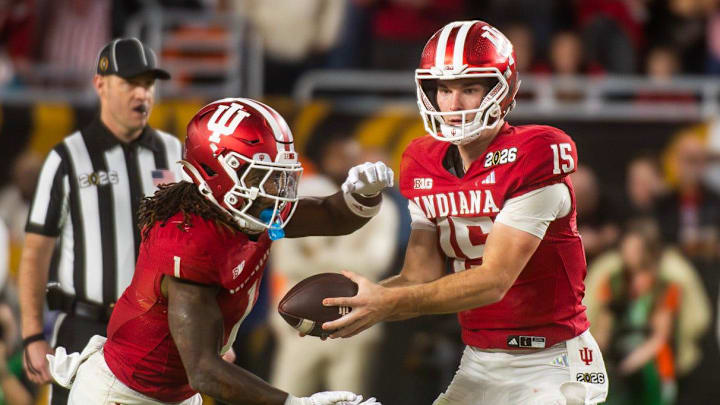 Indiana's Fernando Mendoza hands the ball to Roman Hemby Indiana's Fernando Mendoza hands the ball to Roman Hemby