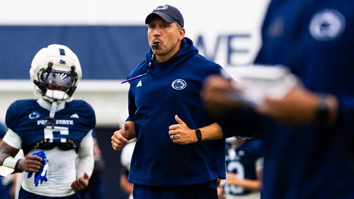 Penn State football head coach Matt Campbell jogs at the start of a practice session inside Holuba Hall on Monday, August 10, 2026, in State College.
